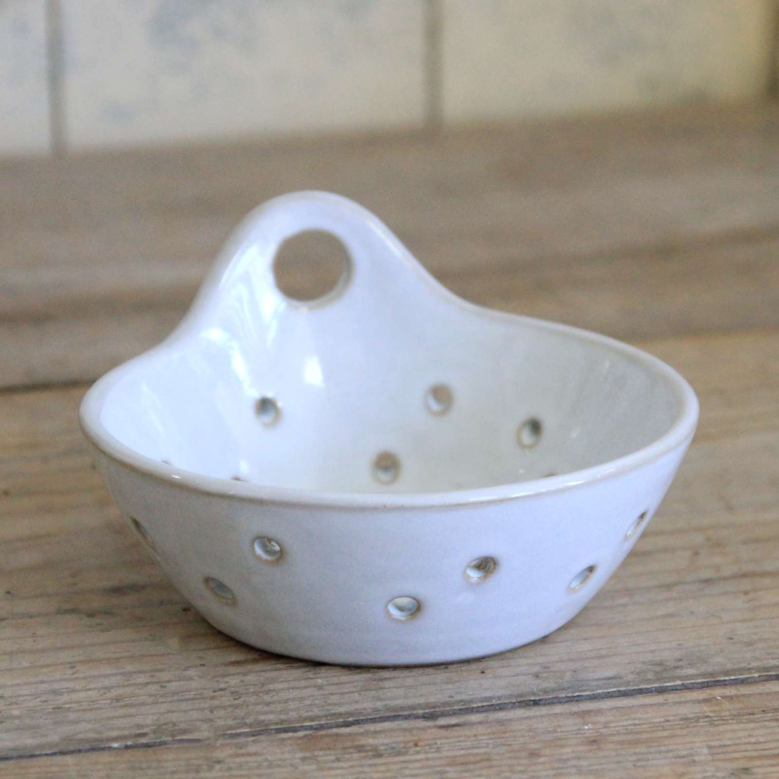 White ceramic colander with holes
