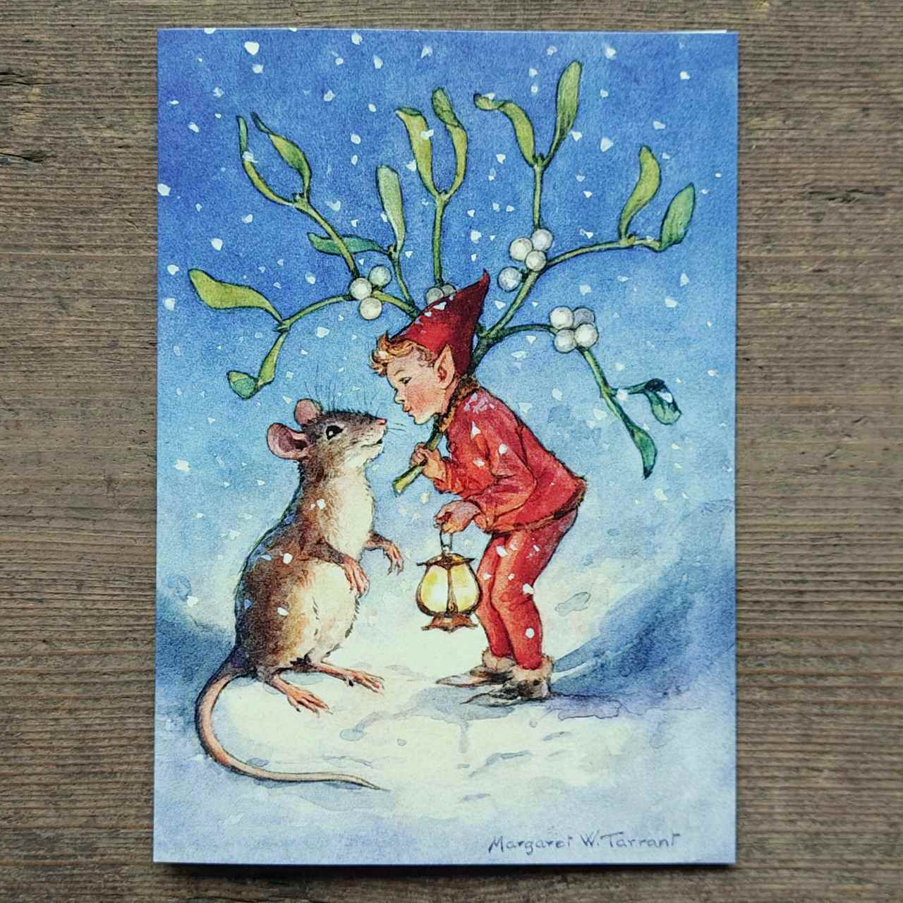 Vintage Illustration of an elf and a mouse with mistletoe on a snowy background