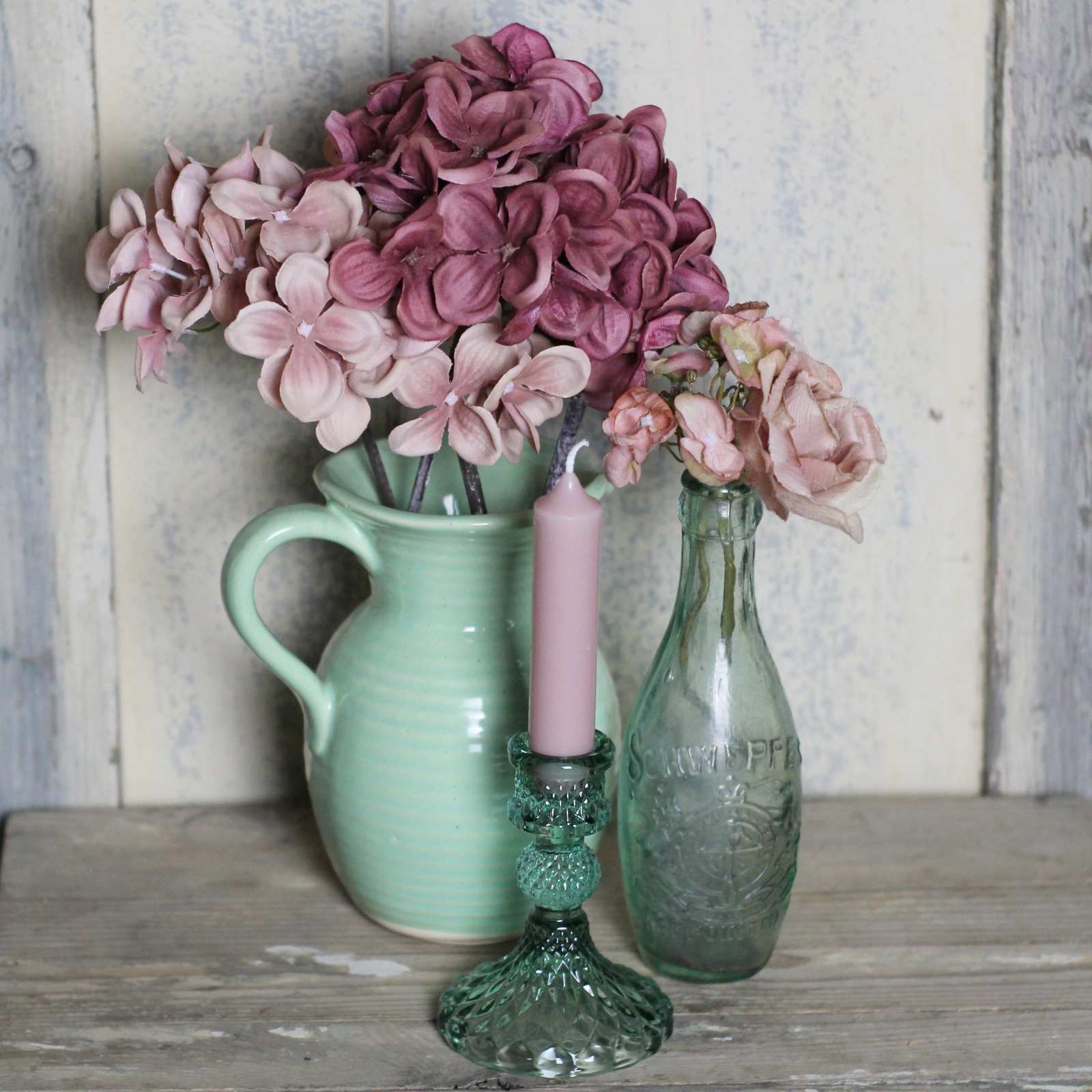 Candlestick in green cut glass with pink candle and green jug