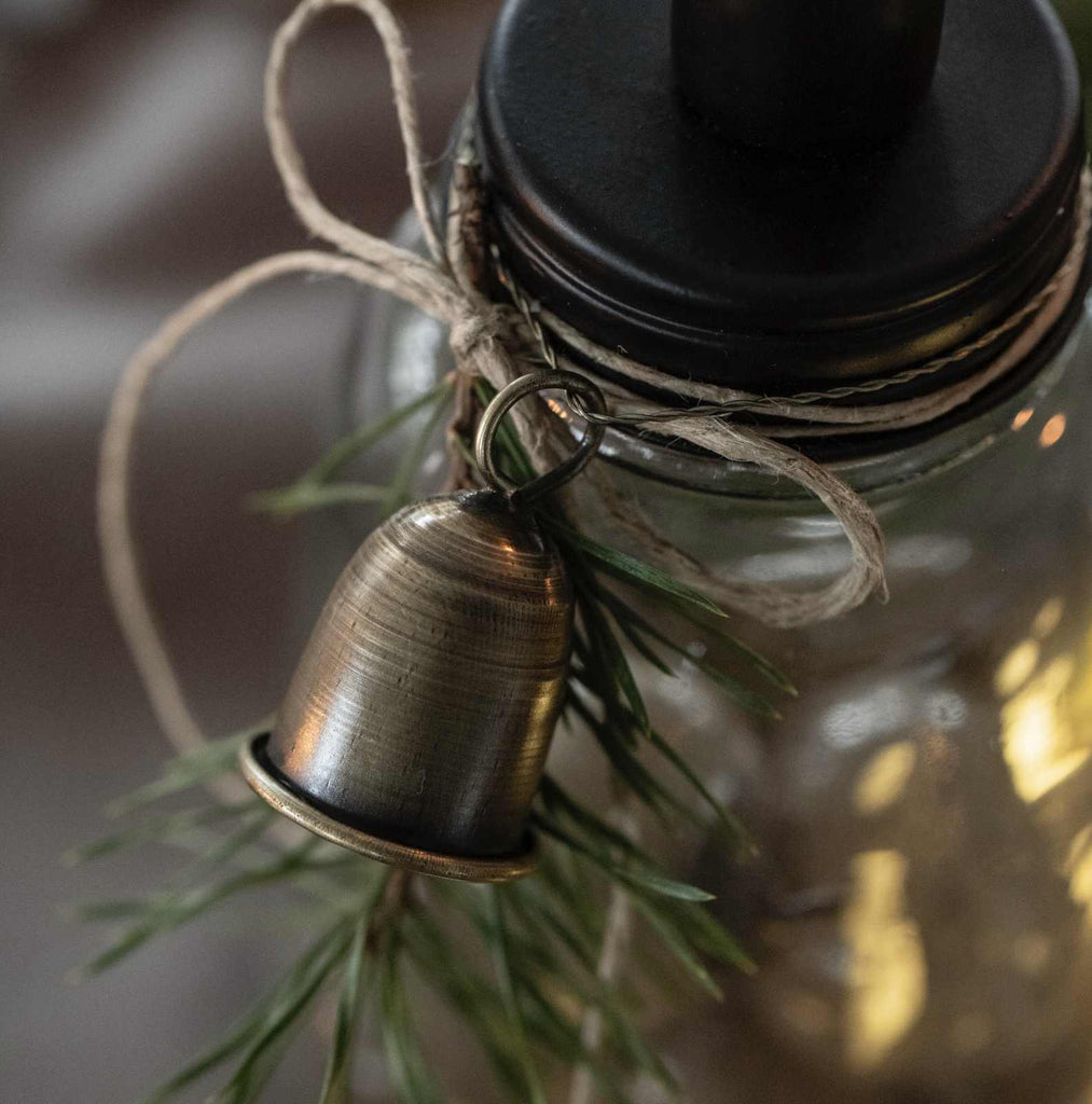 Antique gold bell decoration tied on jar
