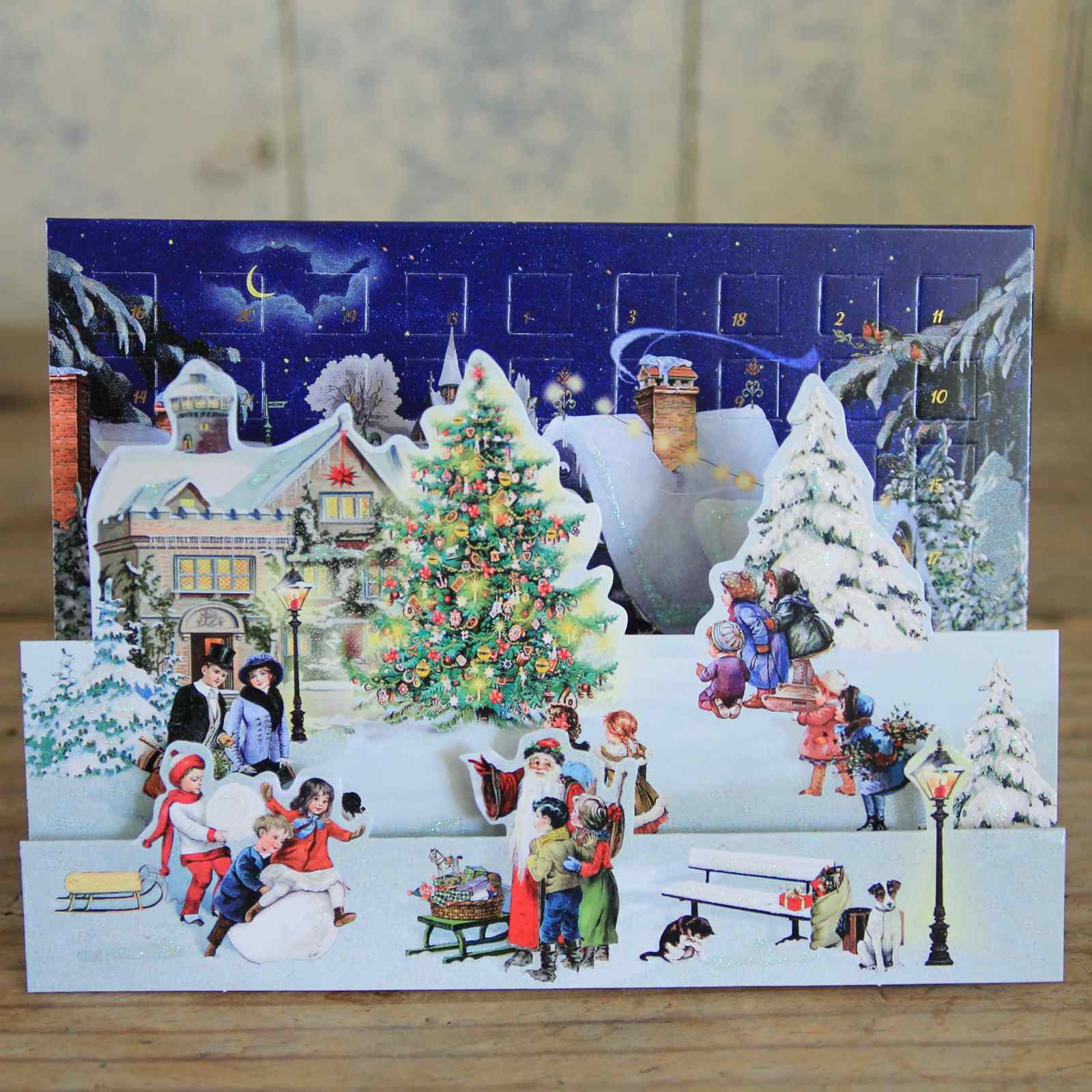 Vintage-style Christmas card with snowy village scene and Advent calendar