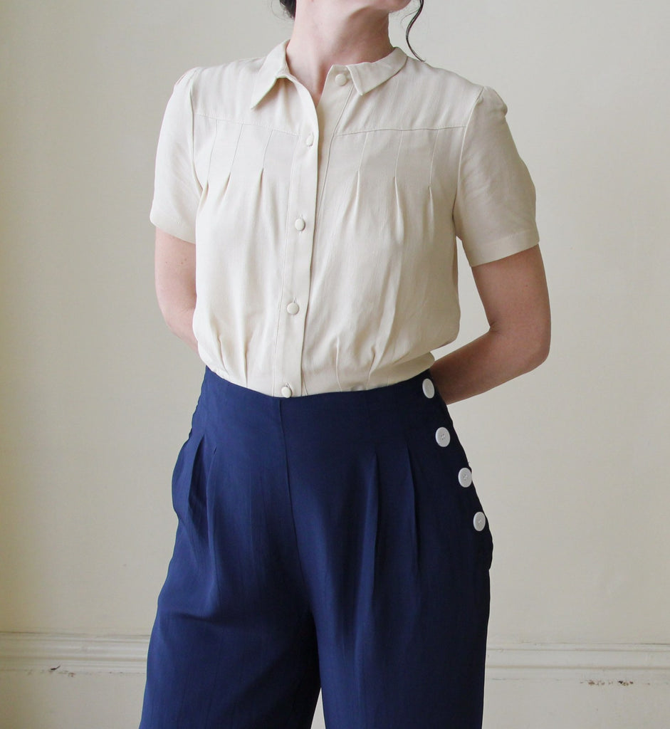 Classic 1940's high waisted, wide legged vintage trousers with white buttons down one side