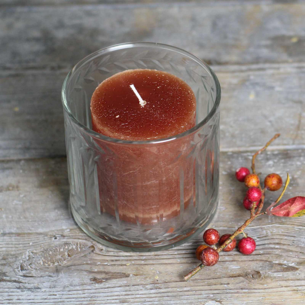 glass candle holder with rust pillar candle