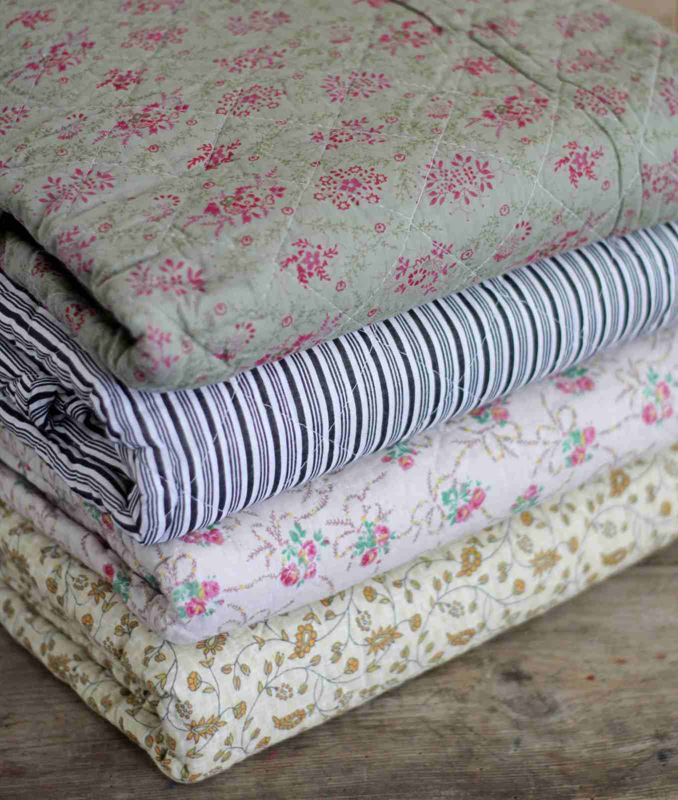 Quilted bedspreads in different patterns detail