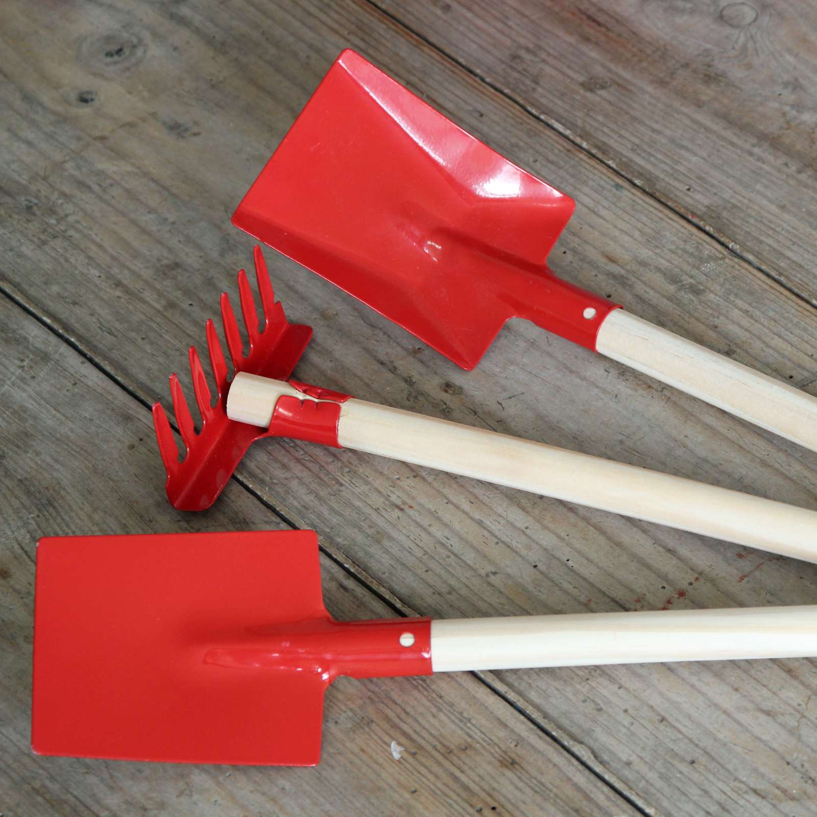 Red enamel and wood gardening tools for children