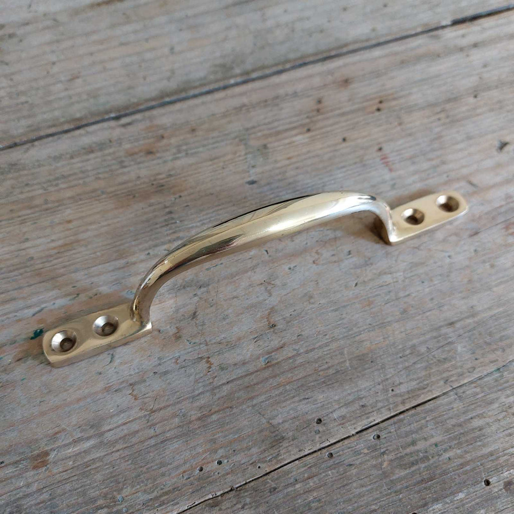 classic vintage brass sash handle, perfect for sash windows, or as a cabinet handle or drawer pull.