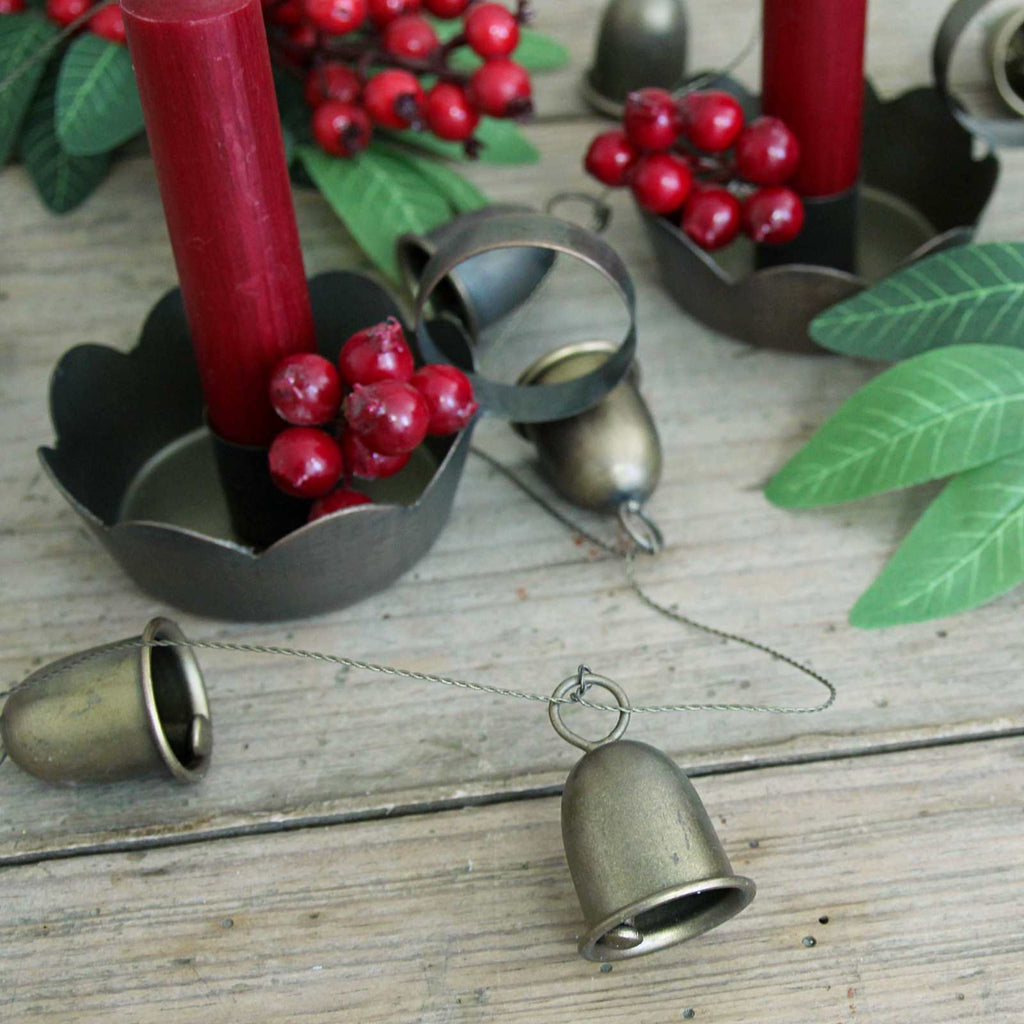 Antique gold bell garland - strung with wire on the Christmas table