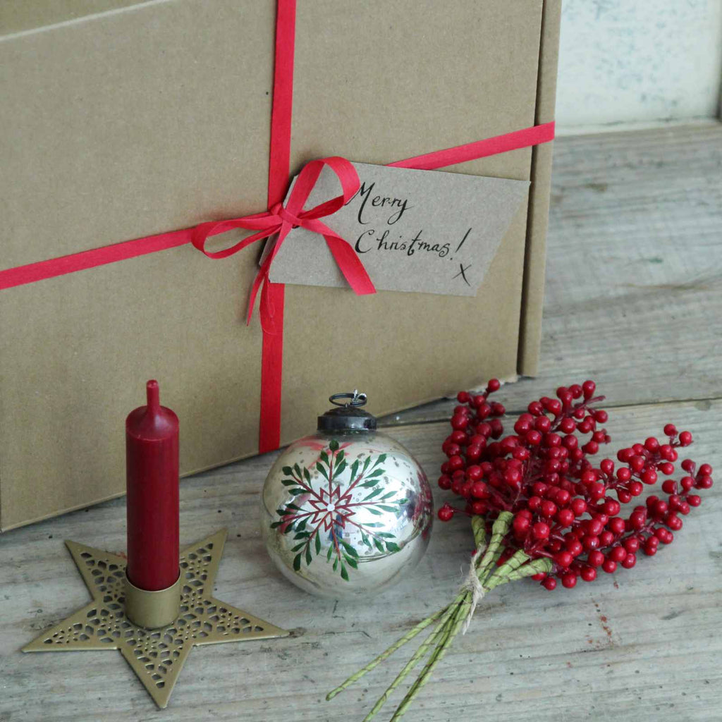 Boxed Gifts - Our 'Snowflake' Christmas Gift Box includes a Gold Star Candle Holder and short red dinner candle, a beautiful Painted Snowflake Silver Bauble, and a festive bunch of red berries. This ready made gift will arrive in a gift box tied with a ribbon, with a hand written tag 'Merry Christmas!' 