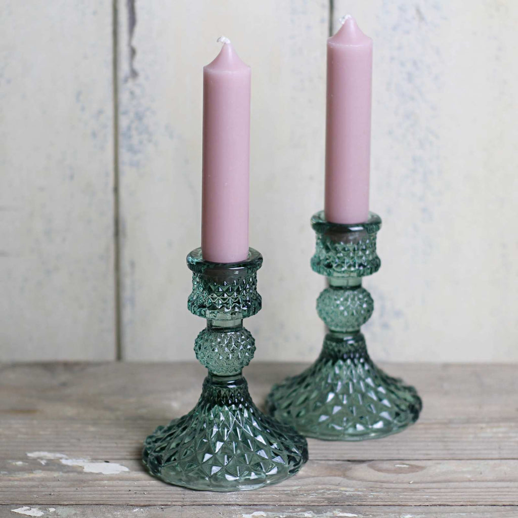 Candlestick in green cut glass with pink candles