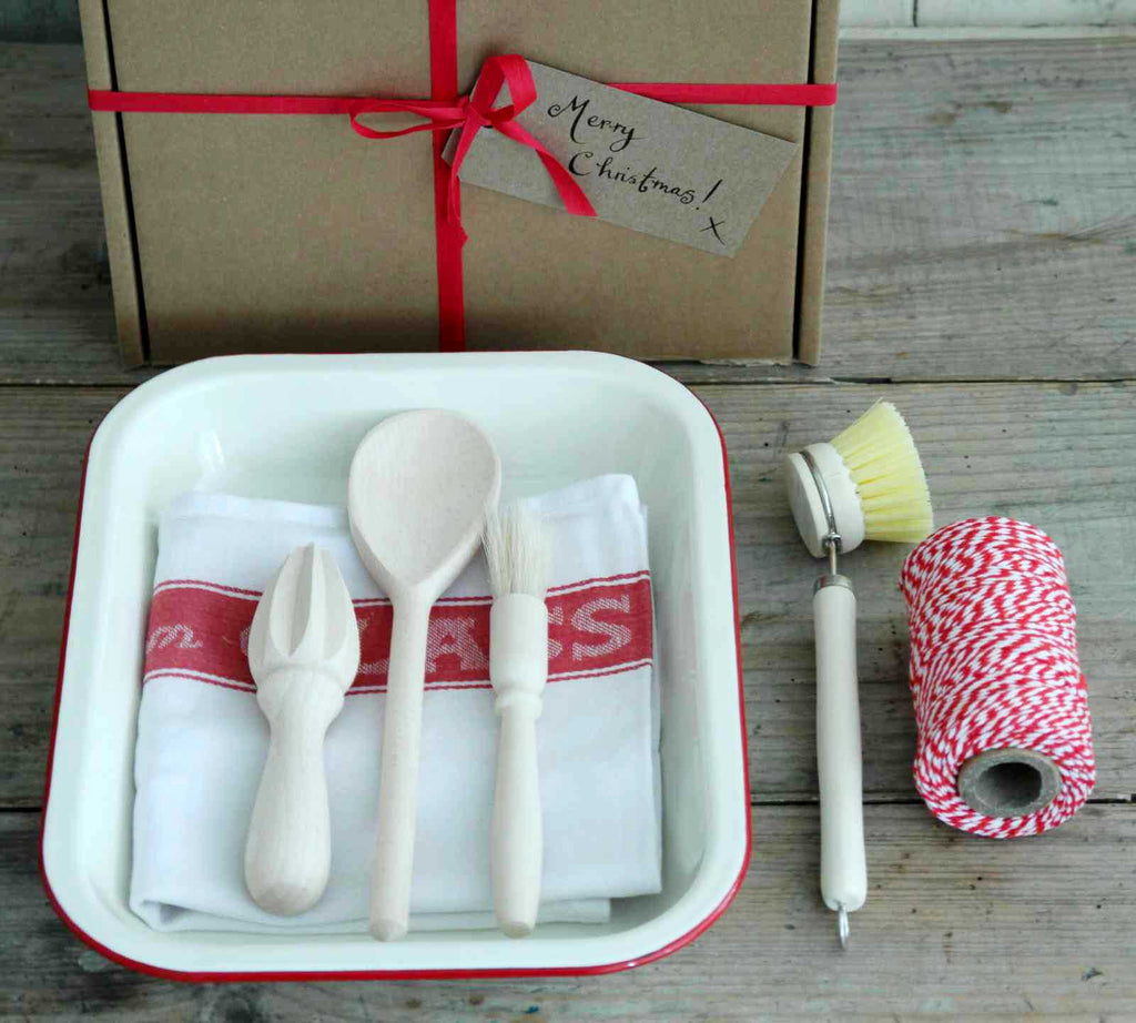 Our 'Kitchen' Gift Box contains an Enamel Roasting Dish in Cream & Red, a cotton Glass Cloth, red and white Baker's Twine, a wooden spoon, a pastry brush, a beech lemon reamer and a wooden dish brush. All the cooking essentials! Boxed Gifts