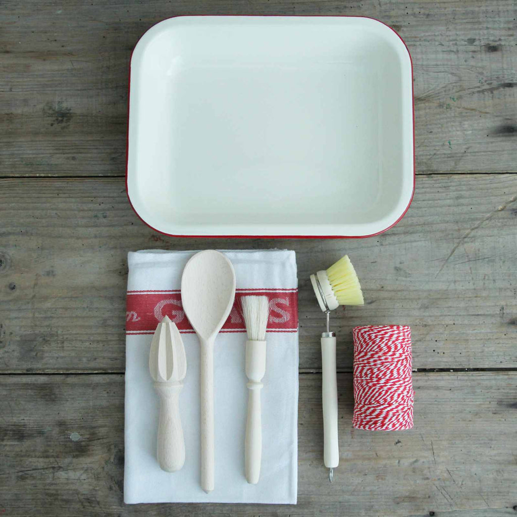 Boxed Gift - Our 'Kitchen' Gift Box contains an Enamel Roasting Dish in Cream & Red, a cotton Glass Cloth, a wooden spoon, a pastry brush, a beech lemon reamer and a wooden dish brush. All the cooking essentials!