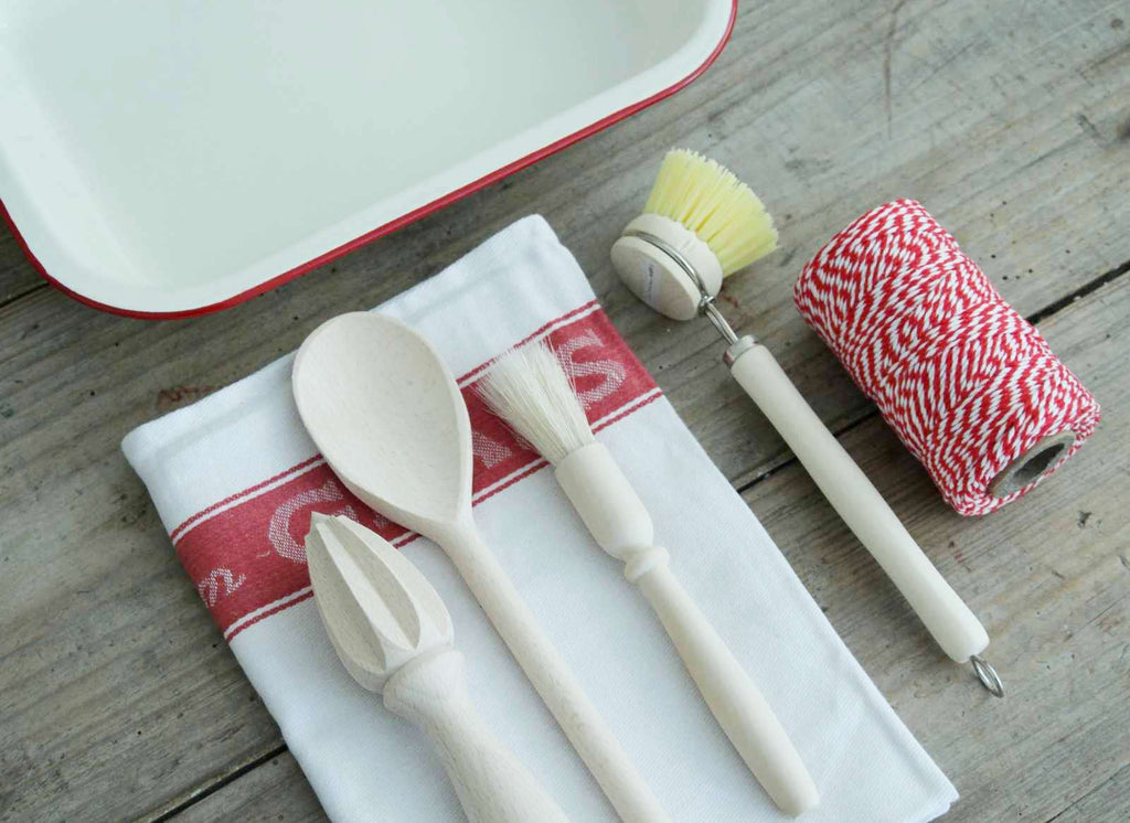 Boxed Gifts - Our 'Kitchen' Gift Box contains an Enamel Roasting Dish in Cream & Red, a cotton Glass Cloth, red and white Baker's Twine, a wooden spoon, a pastry brush, a beech lemon reamer and a wooden dish brush. All the cooking essentials!