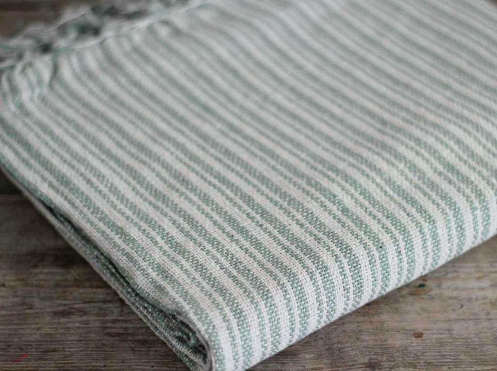 Throw blanket in green stripe detail