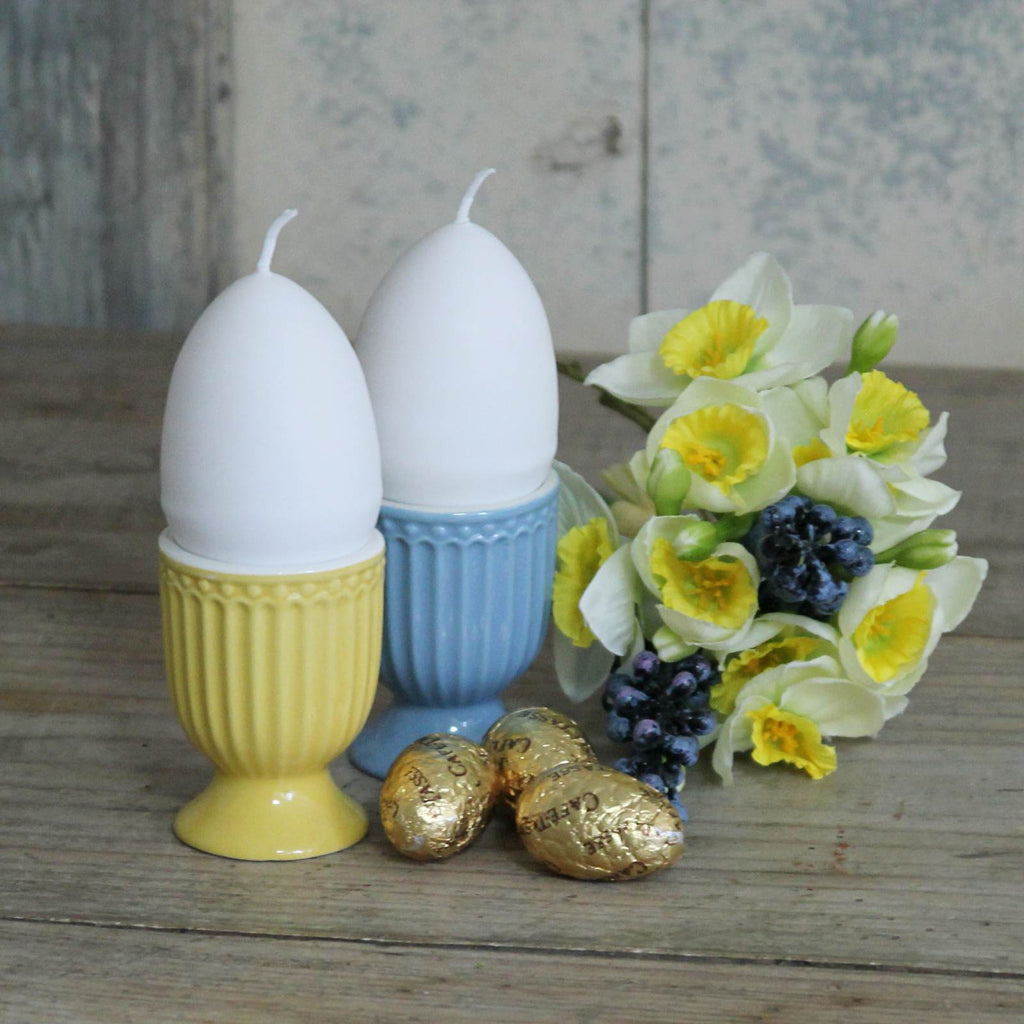 Egg Candle - White egg shaped candle with a yellow interior with egg cups