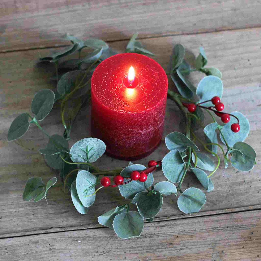 candle holder ring with red berry and eucalyptus and red pillar candle