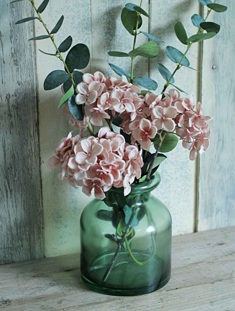 Vintage green glass vase with pink hydrangeas and eucalyptus