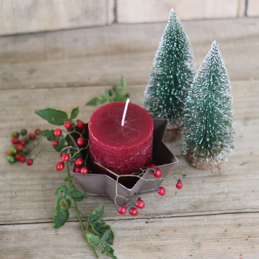 candle holder in metal with berries and christmas tree decorations