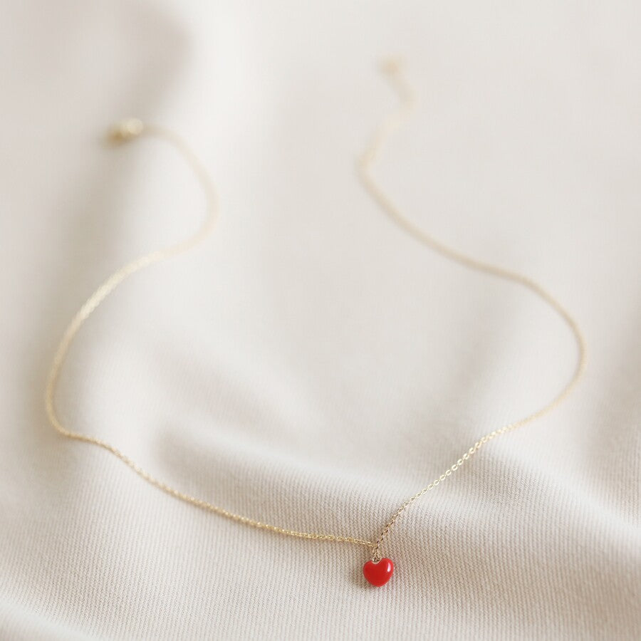 Tiny red heart necklace with a gold chain