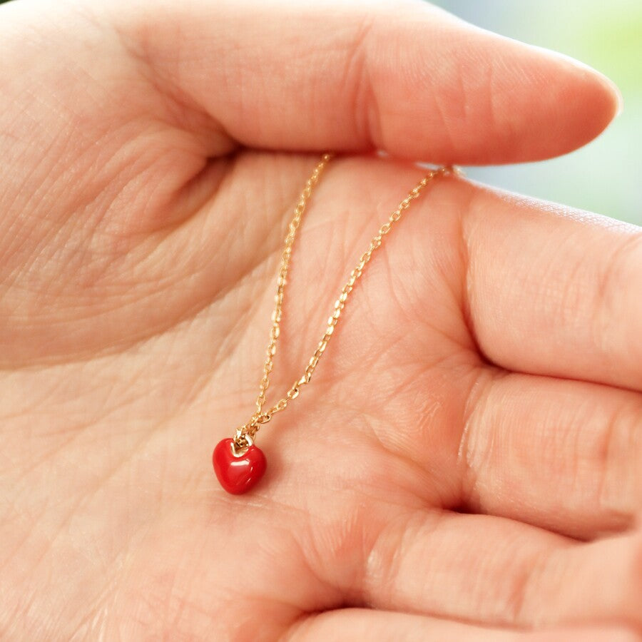 Tiny red heart necklace with a gold chain